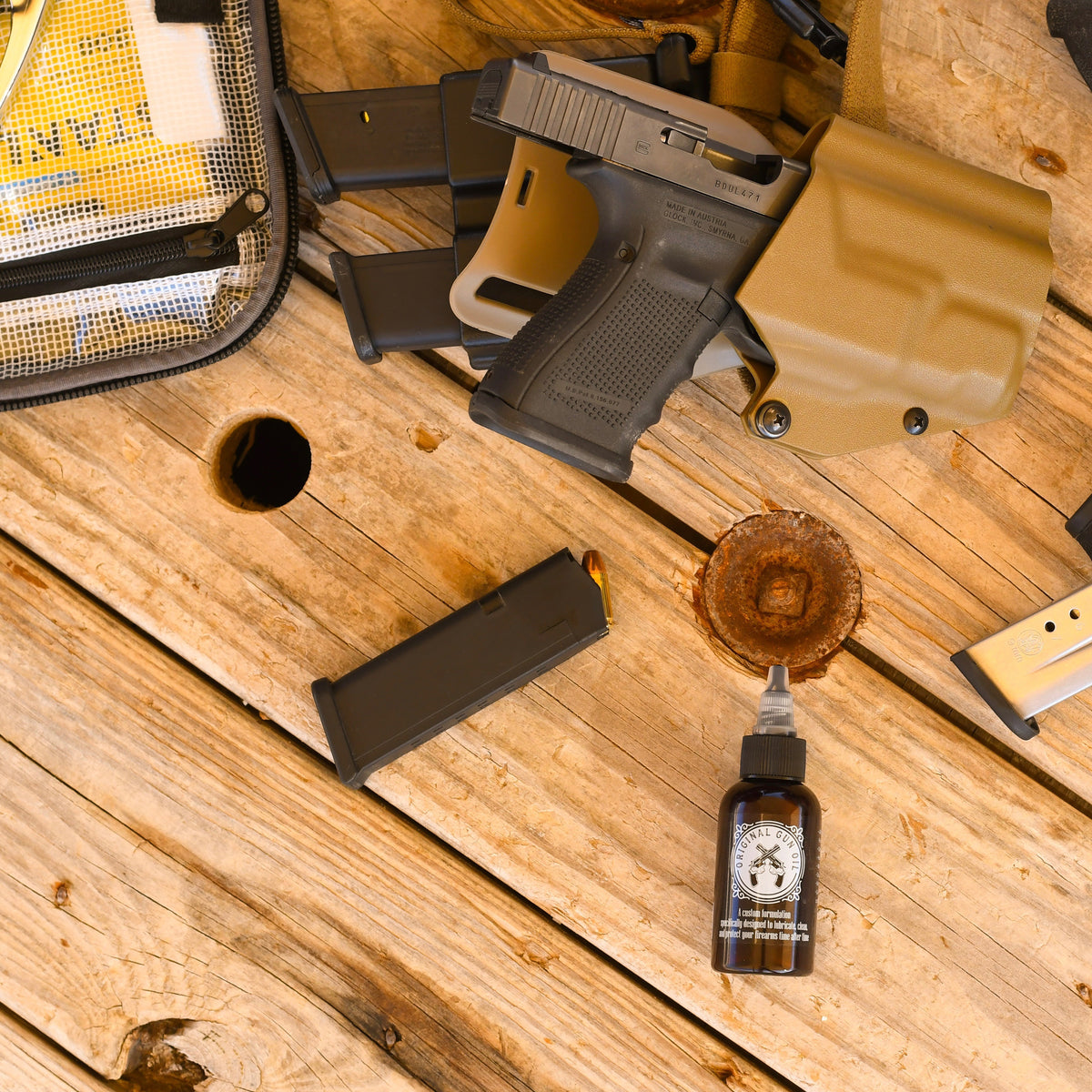 Bottle of Original Gun Oil with Every Day Carry Holster and Hand Gun